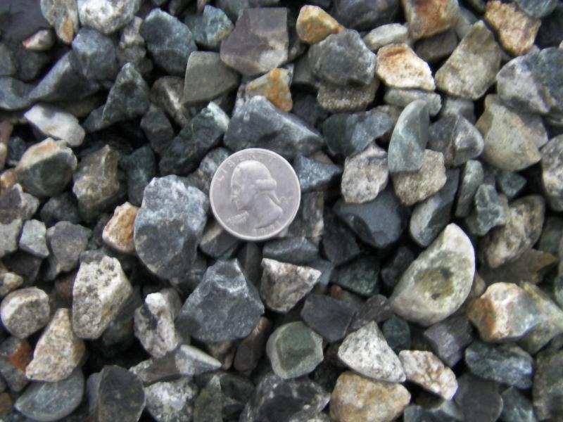 This 5/8th crushed rock has little to no fines in it.  Quarter sued to show size