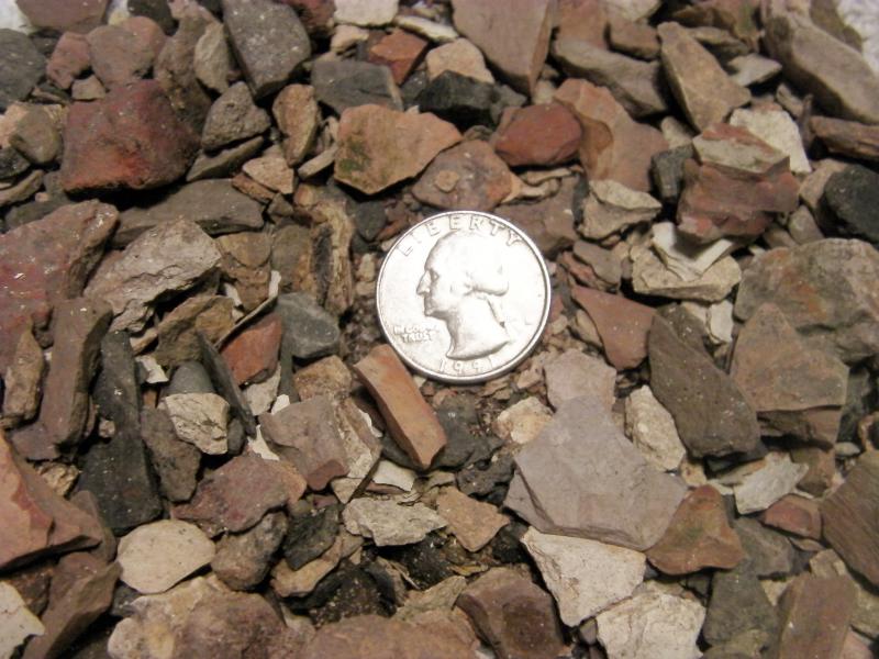 Red Cinders 3/4 inch minus.  Quarter used to help show size.
