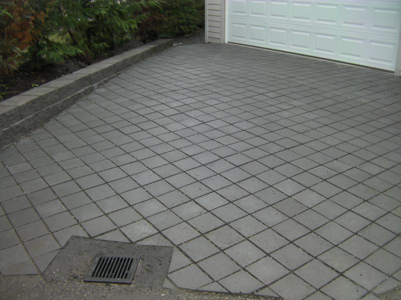 Pervious Paver Driveway with storm drain installed at bottom of slope.